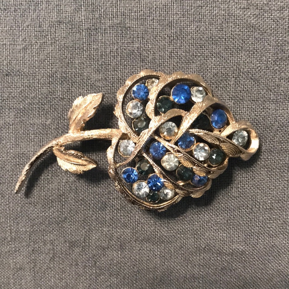 Silver brooch with blue jewels